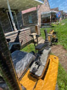 S3E excavator controls and seat in residential setting