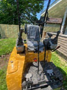 S3E 1-ton excavator on grass in front of a house