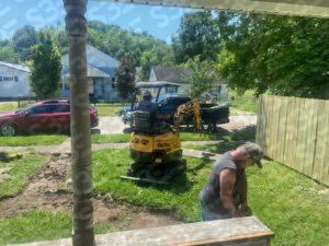S3E 1-ton excavator operating on grass in a residential yard