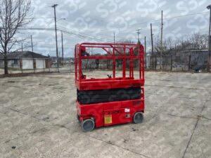 S3E red scissor lift on a concrete lot with residential background