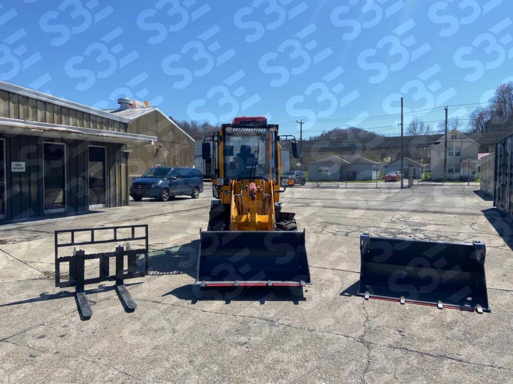 S3E wheel loader with various attachments on a concrete lot