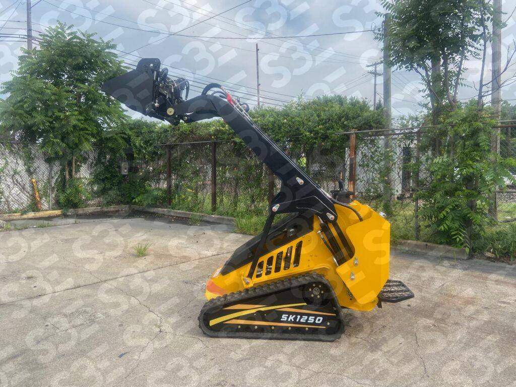 Yellow and black S3E mini skid steer loader on concrete lot